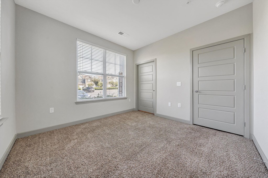 an empty room with a window and a door  at Avellan Springs Apartments, Morrisville, NC, 27560