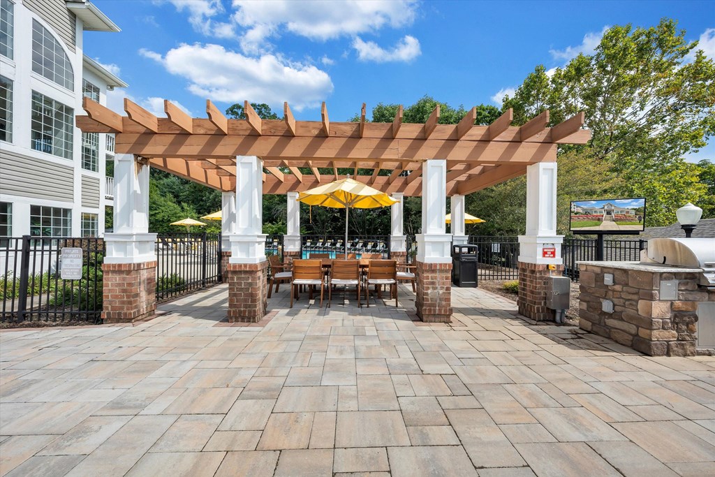 a pergola with a table and chairs under it