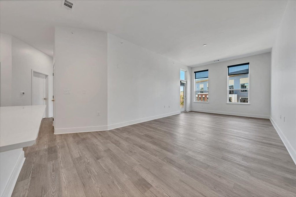a living room with white walls and wood floors at Luxe 360 in Midlothian, Midlothian, 23114