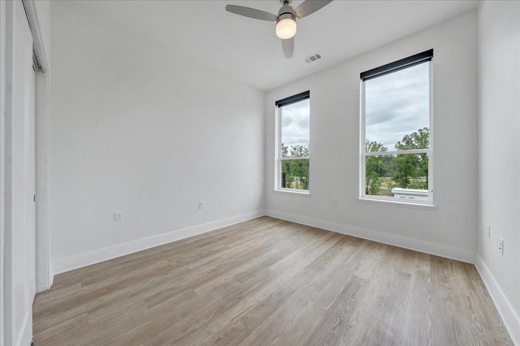 an empty bedroom with windows at Luxe 360 on Centerpointe Apartments, Midlothian