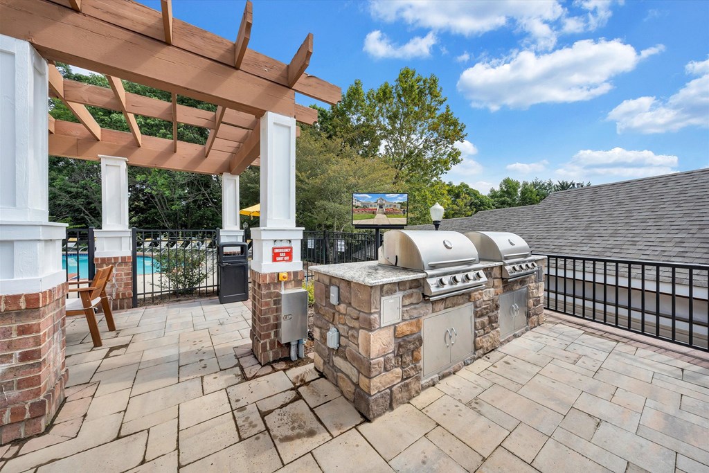 a patio with a pool and a reflection of a building at Sunscape Apartments, Roanoke, VA, 24018