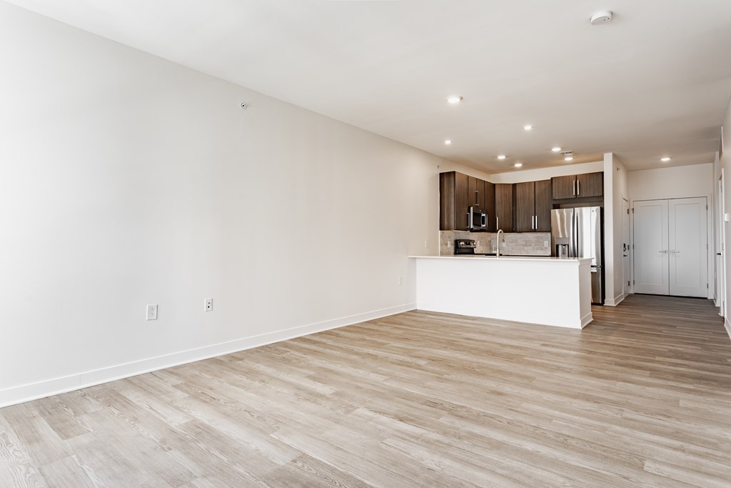 A spacious room with wooden flooring and a kitchen area in the background at Upper Vue Flats, Dublin