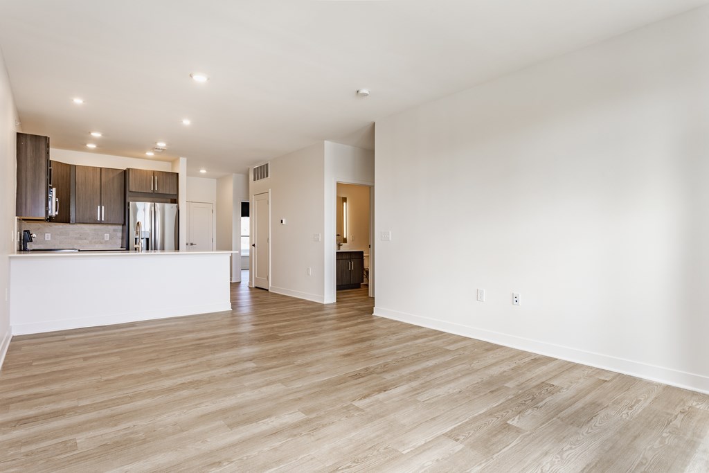 A spacious kitchen with wooden floors and white walls at Upper Vue Flats, Dublin