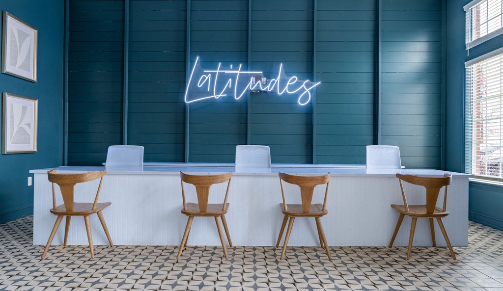 a neon sign in front of a table with four chairs at Latitudes Apartments, Indianapolis, 46237