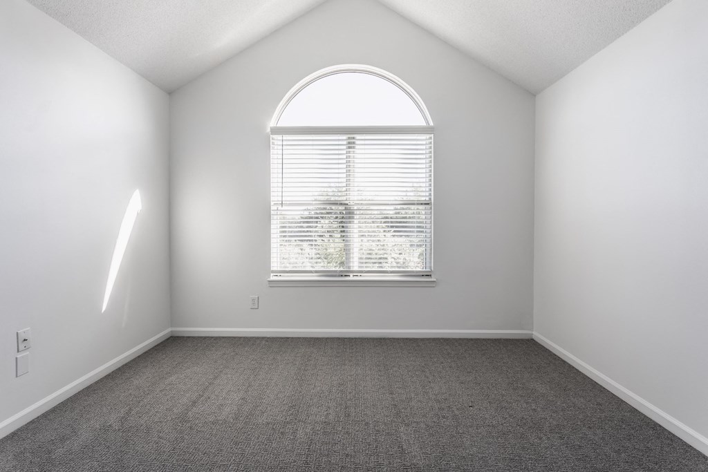 an empty room with a large arched window at Sundance Apartments, Indiana, 46237
