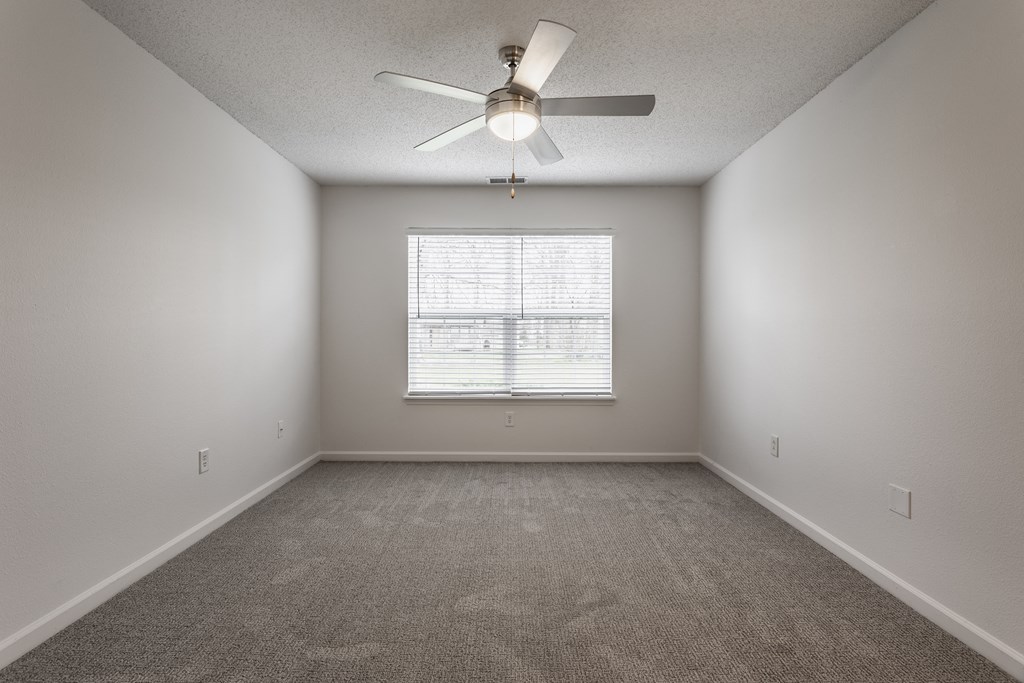 an empty room with a ceiling fan and a window at Latitudes Apartments, Indianapolis, Indiana