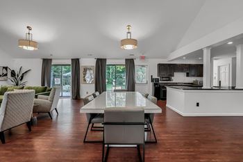 a kitchen and living room with a table and chairs at Polo Run Apartments, Greenwood, 46142