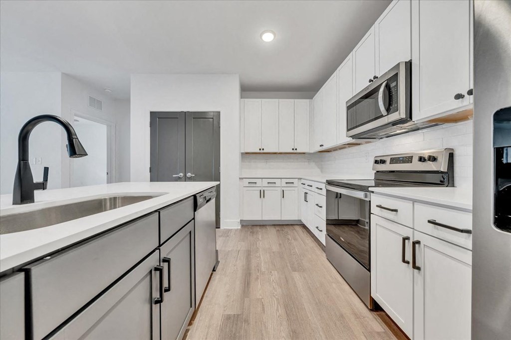 a modern kitchen with white cabinets and stainless steel appliances at Luxe 360 in Midlothian, Midlothian, 23114