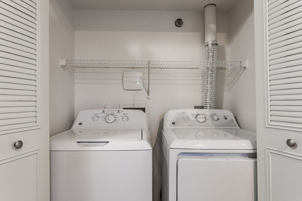 A small laundry room with a washer and dryer at Huntington Cove Apartments, Merrillville, IN, 46410
