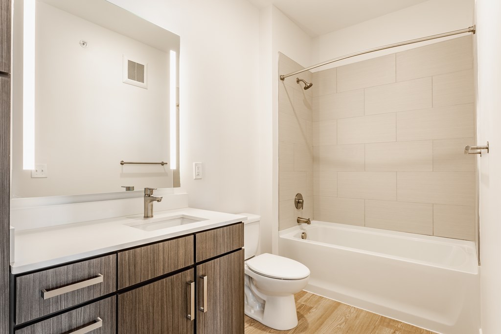 A white toilet sits next to a white sink in a bathroom at Upper Vue Flats, Dublin