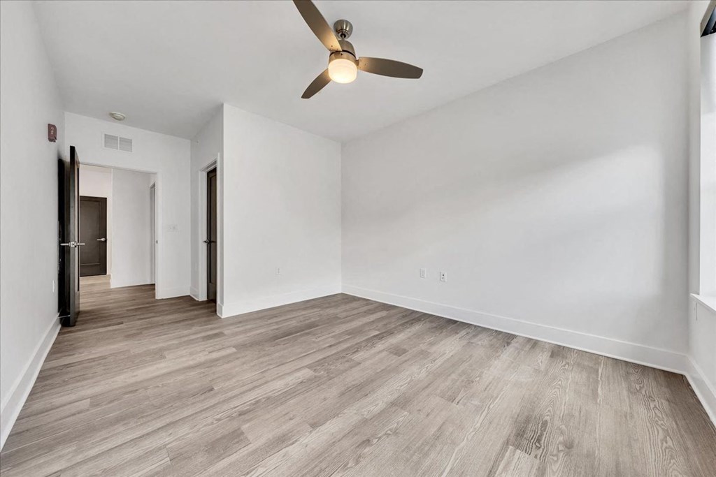 an empty living room with white walls and a ceiling fan at Luxe 360 in Midlothian, Midlothian