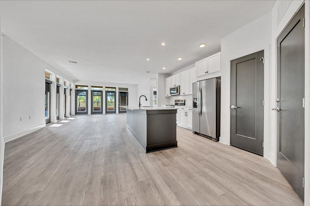 the kitchen is open to the living room and dining room at Luxe 360 on Centerpointe Apartments, Virginia, 23114