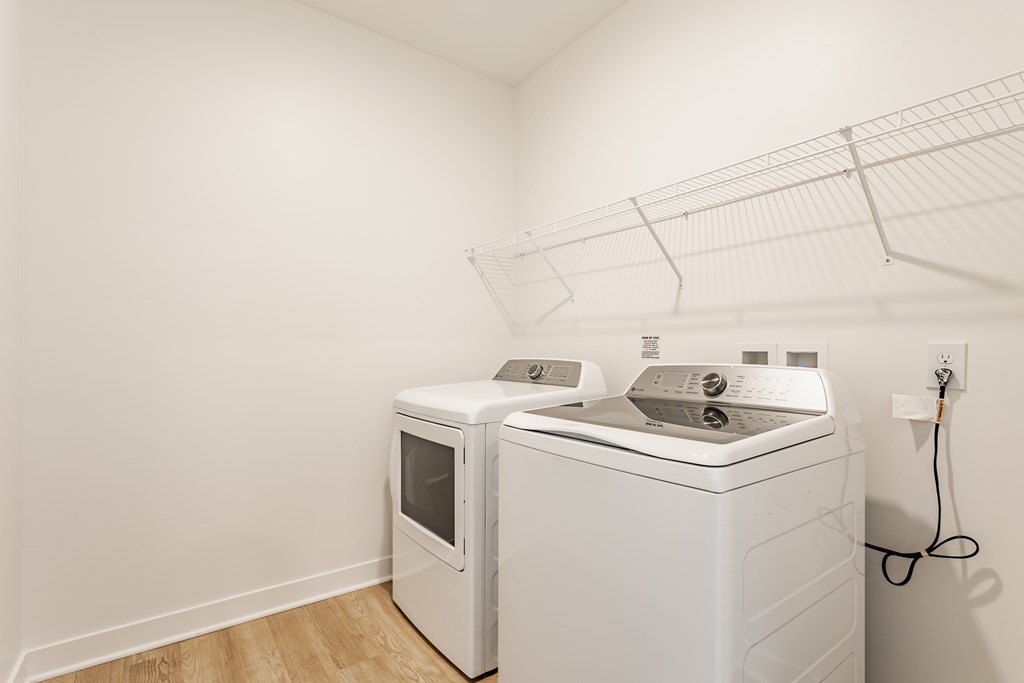 A white dryer and washing machine in a laundry room at Upper Vue Flats, Dublin