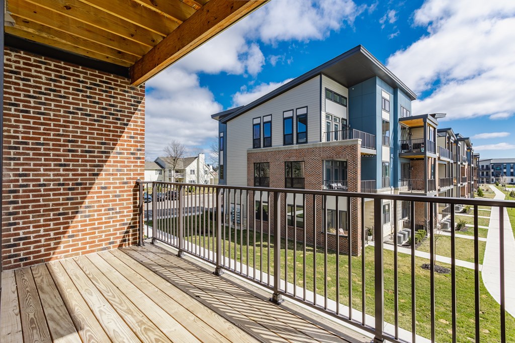 A modern building with a balcony overlooking a grassy area at Upper Vue Flats, Dublin