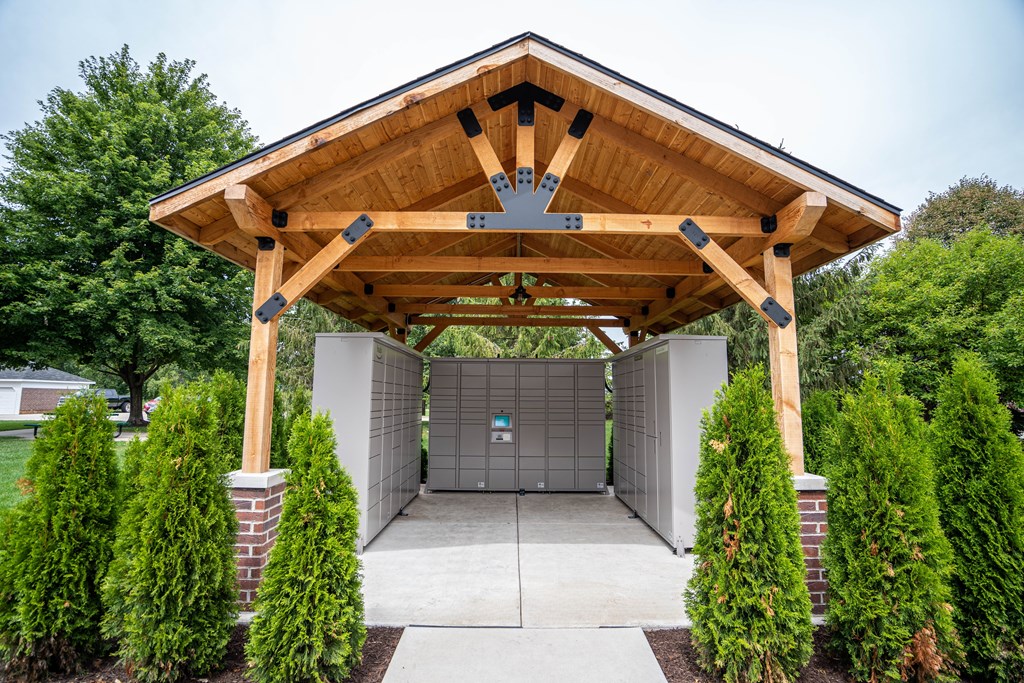 A wooden covered walkway leads to a garage.
