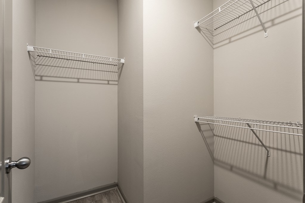 a walk in closet with two white closets and a door at Bella Vista Apartments, Fishers