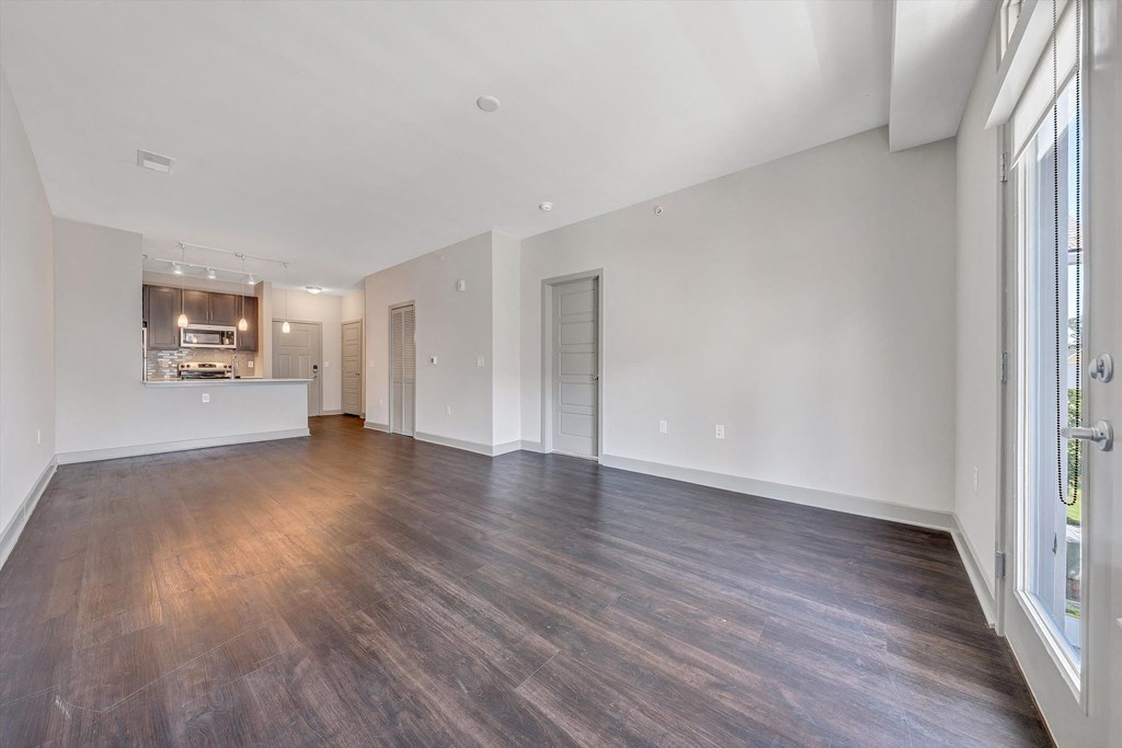 the living room and kitchen of an apartment with wood flooring  at Avellan Springs Apartments, North Carolina