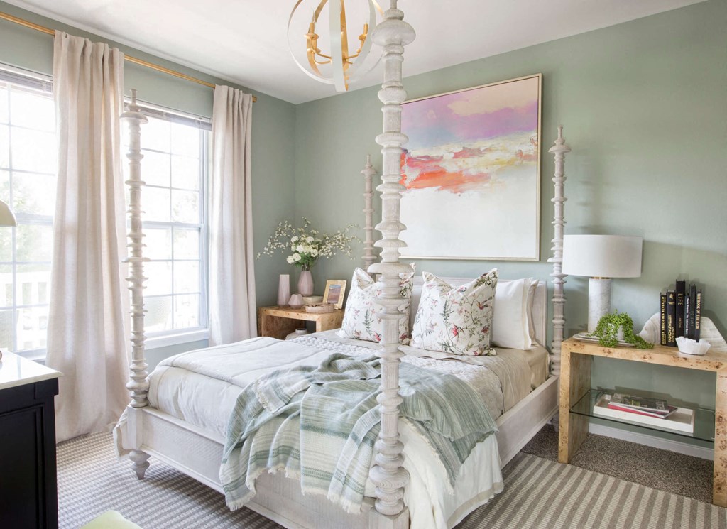 a bedroom with a white four poster bed and a large painting on the wall  at Enclave Apartments, Midlothian