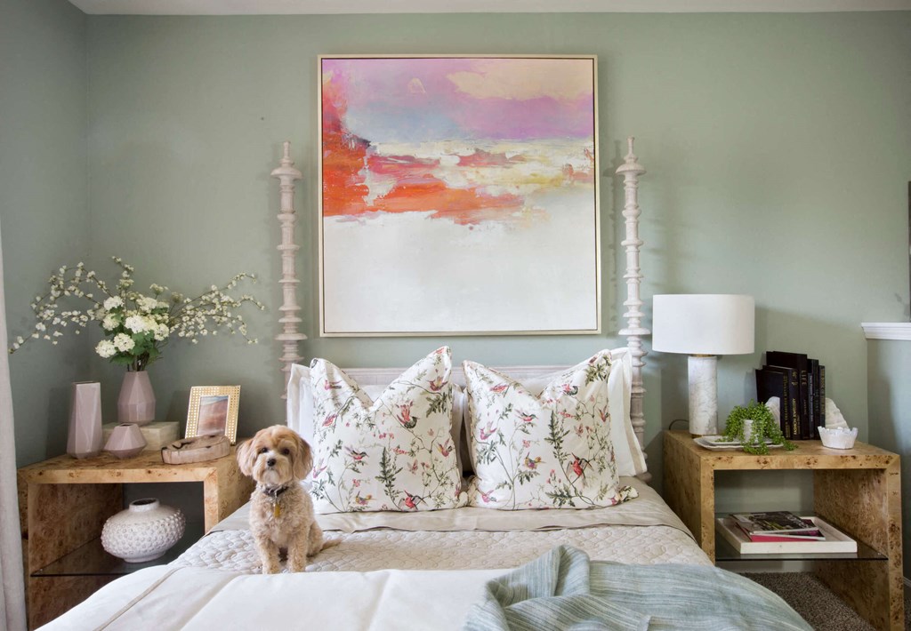 a dog sits on a bed in a bedroom with a painting on the wall  at Enclave Apartments, Midlothian, VA, 23114