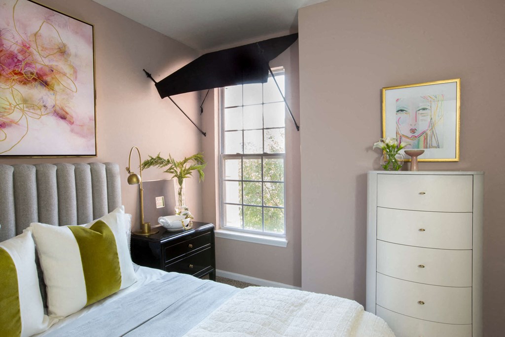 a bedroom with a bed and a dresser  at Enclave Apartments, Midlothian, 23114
