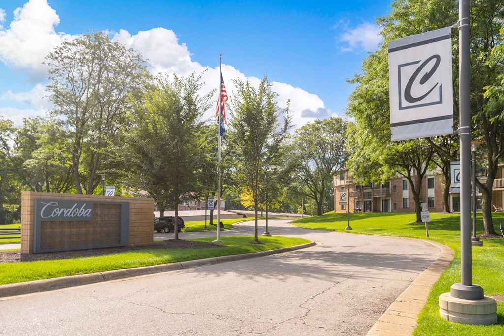 a street with a sign in front of a building at Cordoba Apartments, Farmington Hills