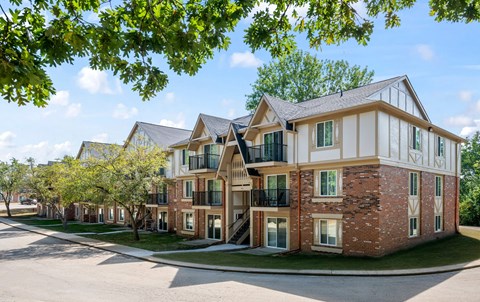 A large brick building with a white trim and a balcony on the second floork at Timberlane Apartments, Peoria, Illinois