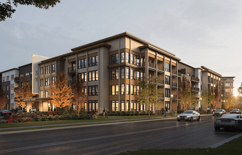 A modern apartment building with cars parked in front.