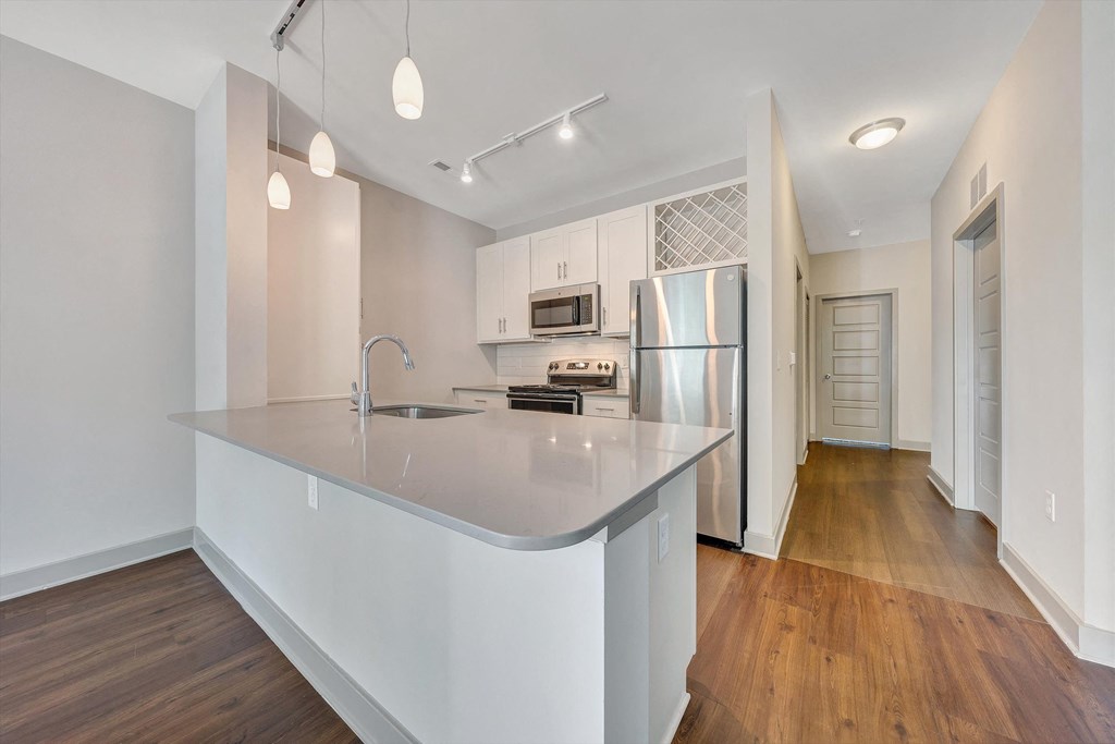 a kitchen with a large island and a stainless steel refrigerator  at Avellan Springs Apartments, Morrisville, NC, 27560