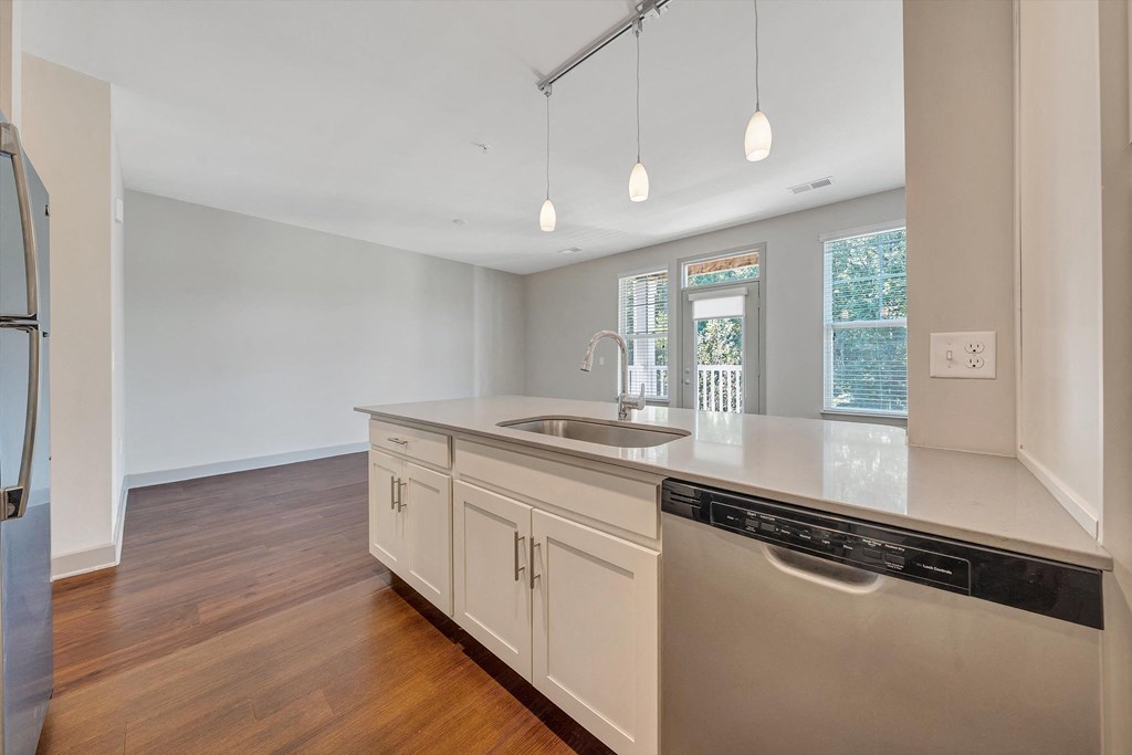 a kitchen with white cabinets and a sink and a dishwasher  at Avellan Springs Apartments, North Carolina, 27560