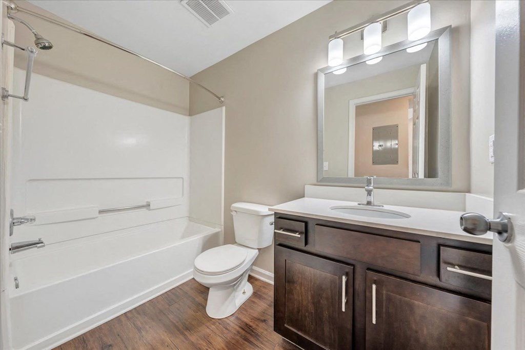 a bathroom with a sink toilet and a bath tub