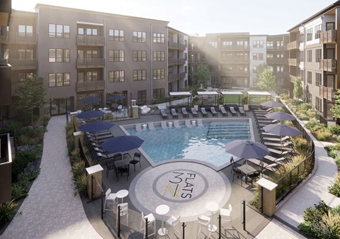 A pool surrounded by a fence and chairs with the words "FLATS" on the side.