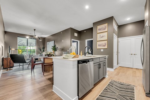 A modern kitchen with a dining table and chairs.