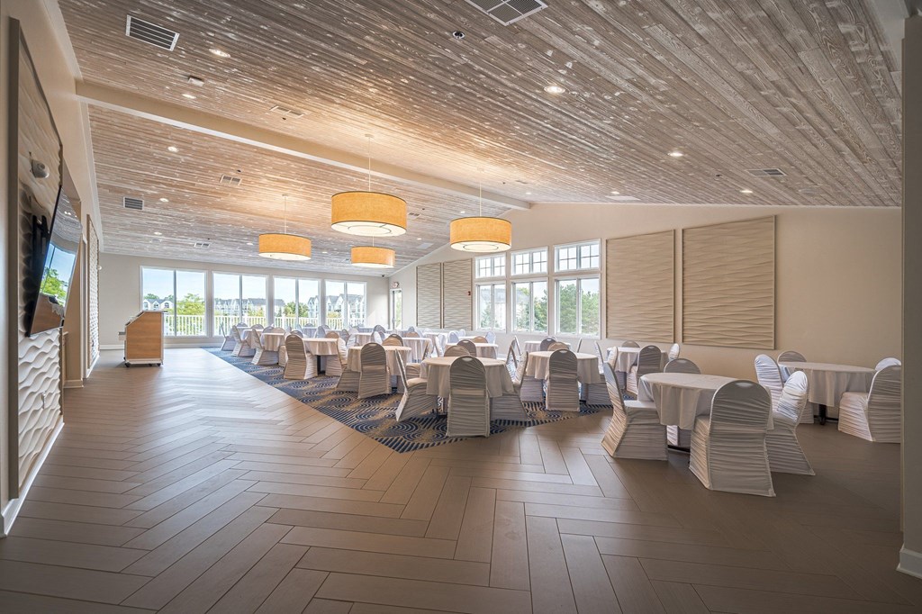 a large room with tables and chairsat The Harbours Apartments, Clinton Twp, MI, 48038