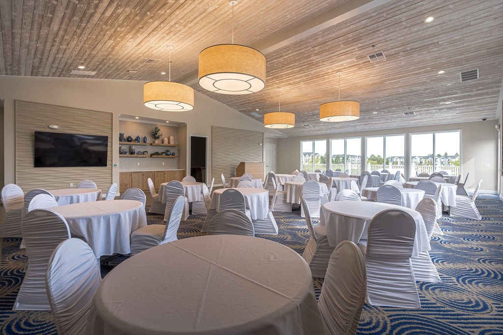 a large room with tables and chairsat The Harbours Apartments, Michigan
