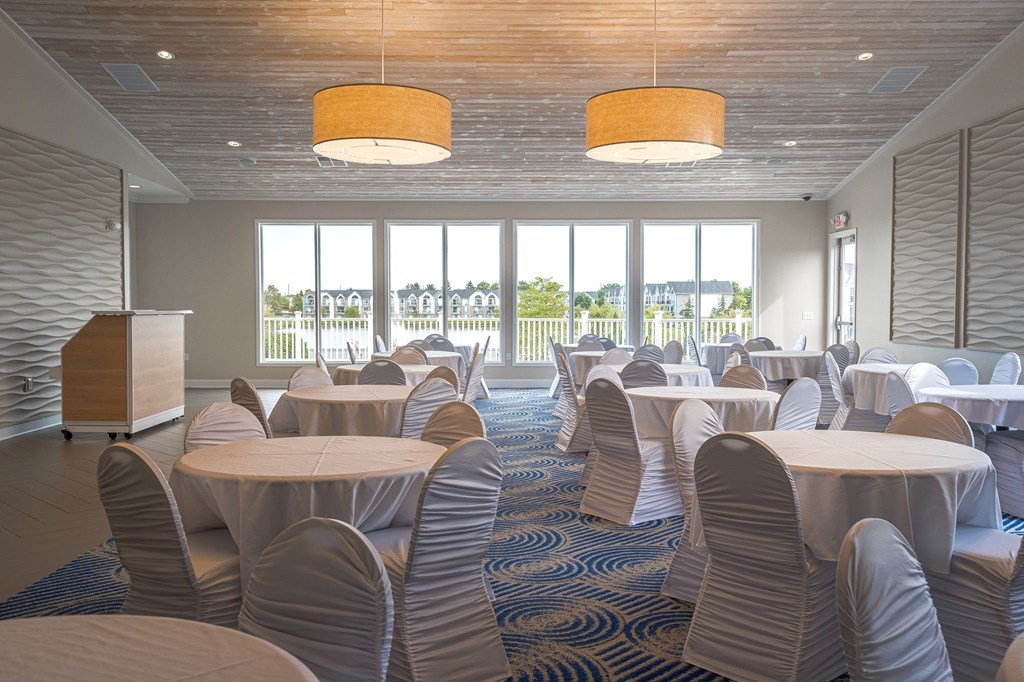 a large room with tables and chairs and a podiumat The Harbours Apartments, Michigan