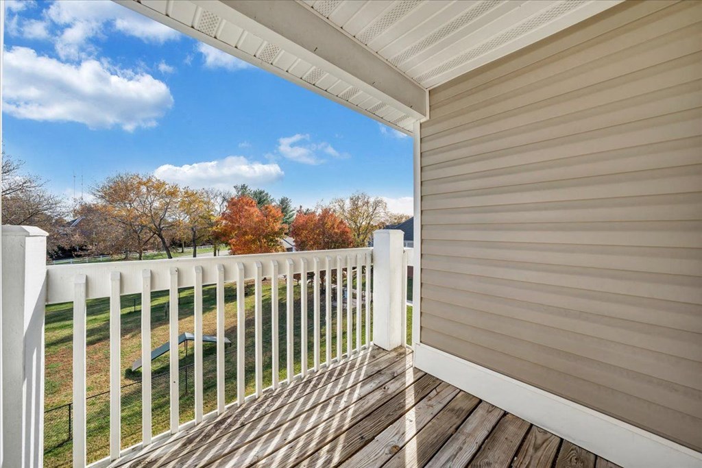 the view from the deck of a home with a white fence
