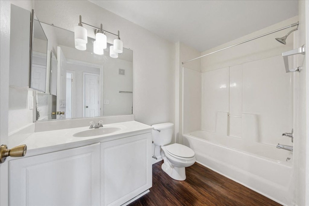 a bathroom with a toilet sink and bathtub  at Enclave Apartments, Midlothian