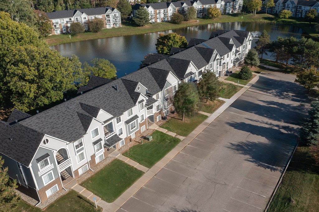 A row of houses with a lake in the background.