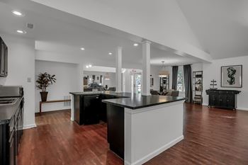 an open kitchen and living room with a large counter top at Polo Run Apartments, Greenwood