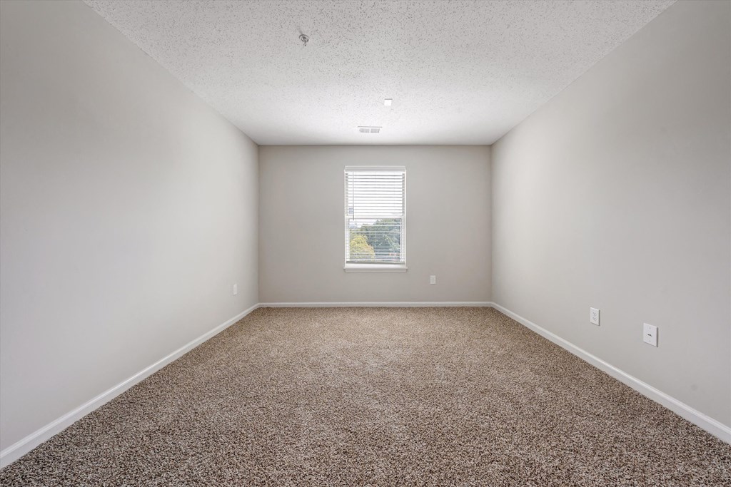 an empty room with a window at Sunscape Apartments, Roanoke, Virginia