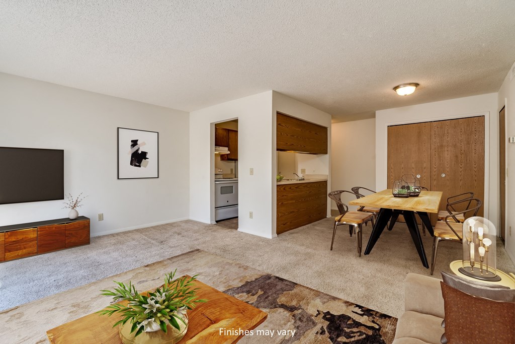 a spacious living room with a dining room table and a kitchen in the background at Brook Pines, South Carolina