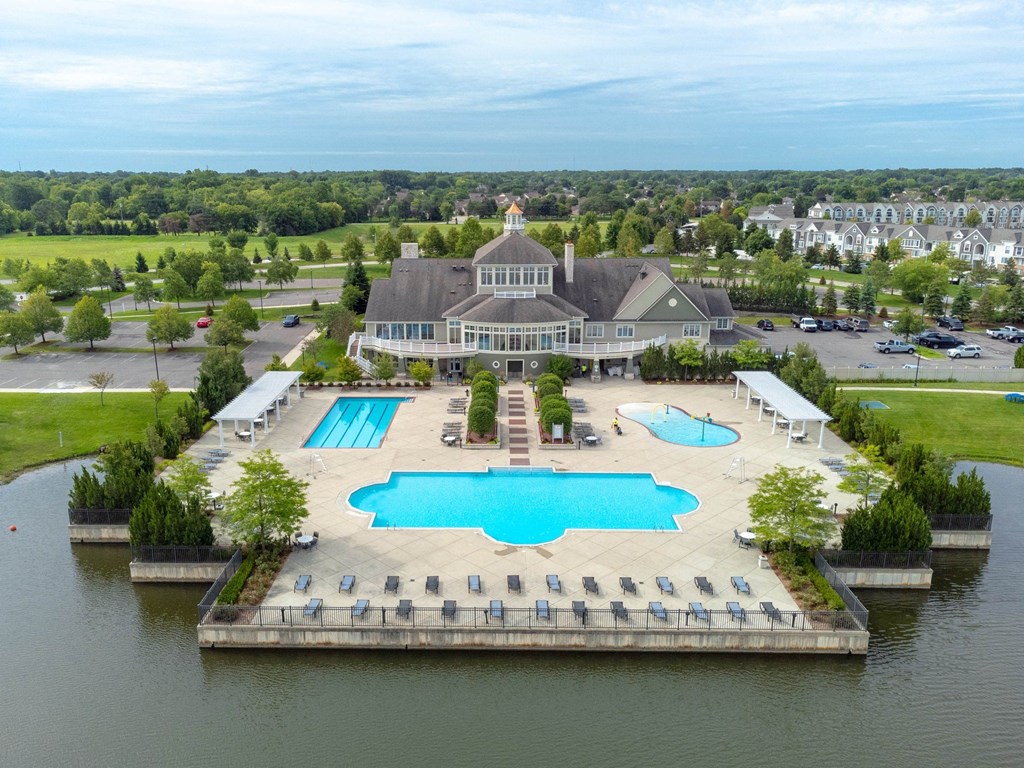 an aerial view of a large pool with a building in the backgroundat The Harbours Apartments, Michigan, 48038