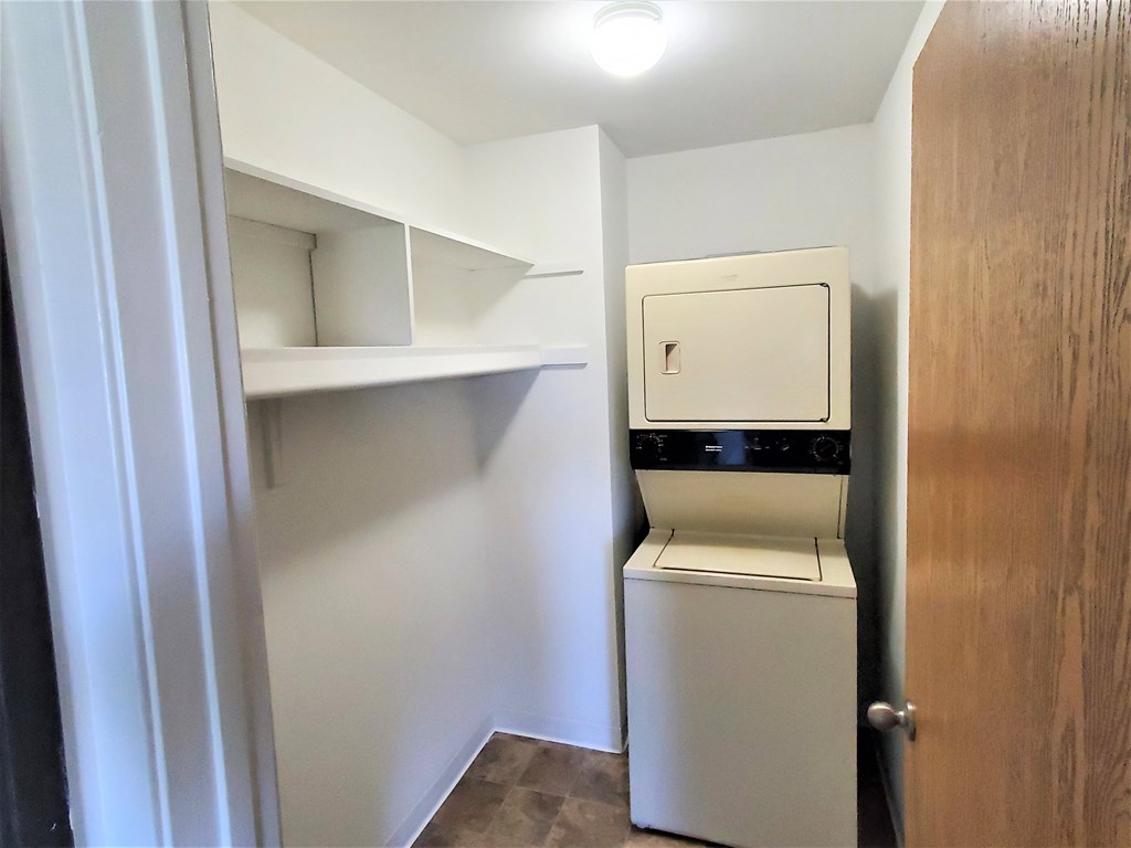 A small laundry room with a washer and dryer.
