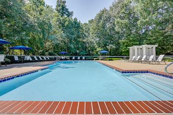 a resort style pool with lounge chairs and umbrellas  at Trophy Club at Bellgrade, Virginia