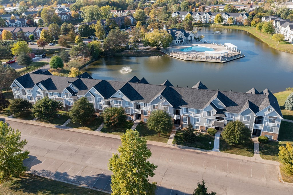 A row of houses with a lake and a boat docked in front.