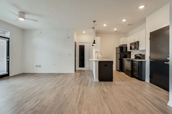 a kitchen and living room in a bedroom plus den unit  at Uptown Square Apartments, Troy, MI