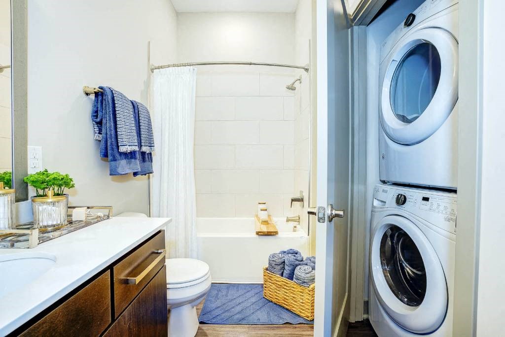 a bathroom with a washer and dryer in it  at Avant & Avant II, Carmel, 46032