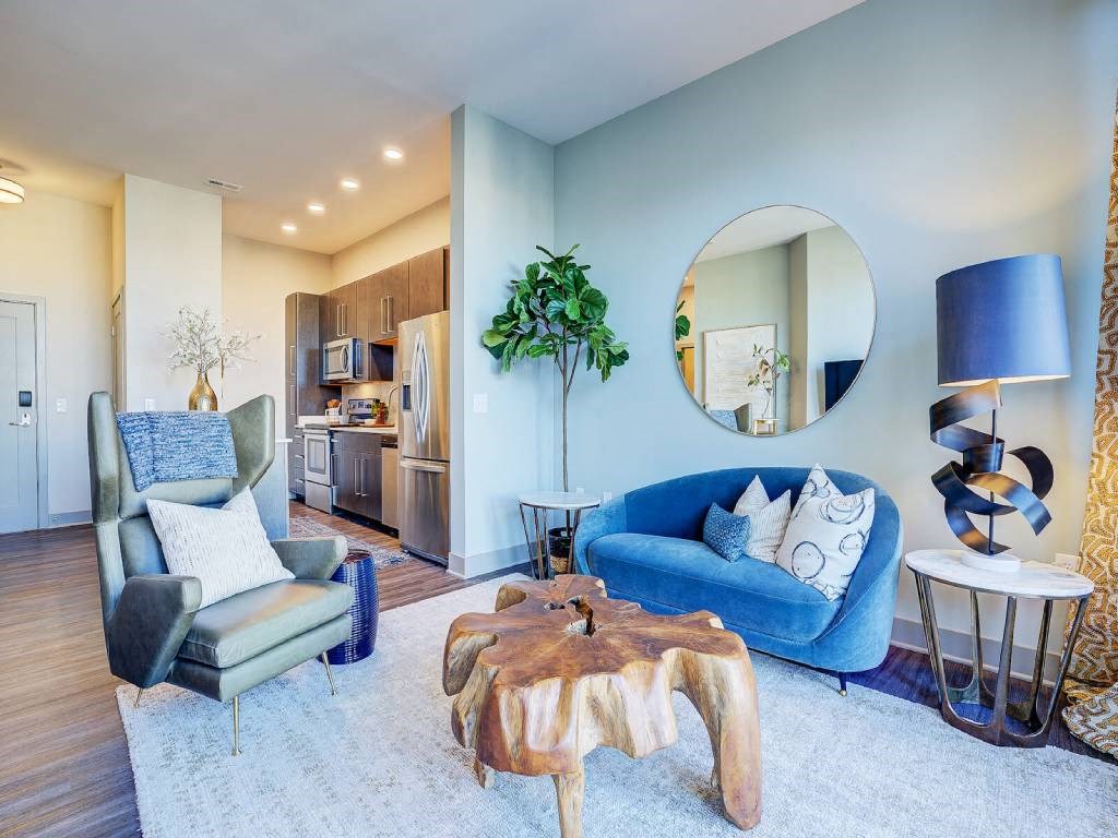 a living room with a blue couch and a chair