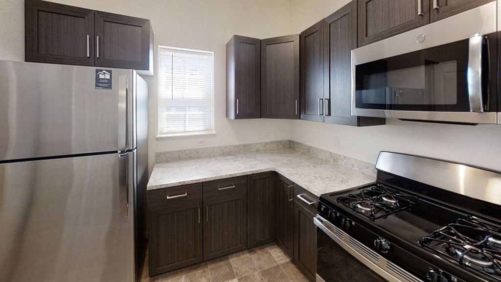 an end style kitchen with stainless steel appliances and black cabinetsat Andover Pointe Apartment Homes, La Vista, 68138