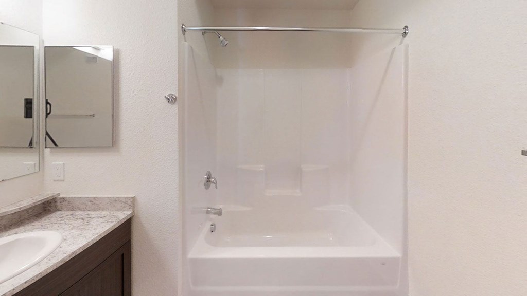 a bathroom with a tub and a sink and a shower at Andover Pointe Apartment Homes, La Vista, NE 68138